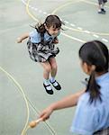 School girl skipping rope