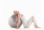 Mature woman lying on exercise ball
