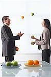 Business People Juggling Apples and Oranges