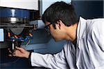 Automotive Engineer Inspecting Machinery