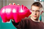 Man Holding Molded Plastic Pig