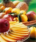 Sliced mango with a basket of fruit