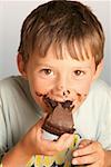 Boy eating a piece of chocolate cake