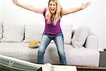 Young woman cheering in front of TV