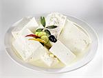 Several pieces of feta cheese in brine