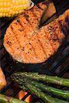 Salmon steak and vegetables on a barbecue
