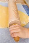 Child's hands rolling out dough