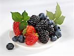 Blueberries, strawberries and blackberries on plate