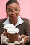 Businesswoman offering two cups of coffee