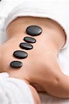 Woman having LaStone Therapy (healing therapy using stones)