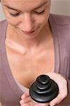 Woman holding stones for LaStone Therapy