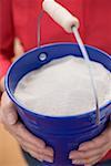 Woman holding bucket of sand (4th of July, USA)