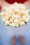 Woman holding popcorn in bowl with stars (4th of July, USA)