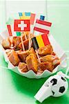 Currywurst with various flags in paper dish