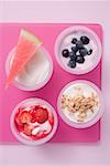 Assorted yoghurts with berries, melon and cereal