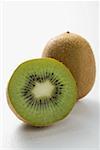 Whole kiwi fruit and half a kiwi fruit