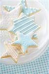 Star biscuits with blue and white icing on plate