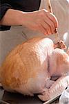 Brushing turkey with marinade