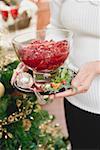Woman holding bowl of cranberry sauce (Christmas)