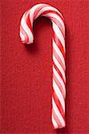 Candy cane on red background