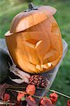 Carved pumpkin face on garden table