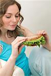 Woman holding wholemeal avocado and watercress sandwich