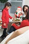 Girl and two women eating stuffed mushrooms (Christmas)