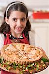 Girl holding freshly-baked apple tart