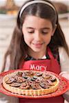 Girl holding freshly-baked fig tart