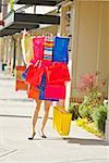 Woman balancing assorted shopping bags