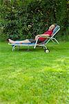 Man relaxing in lounge chair in backyard