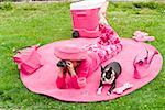 Woman in pink and dog picnicking