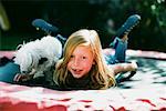 Girl with Dog on Trampoline, Costa Mesa, California, USA