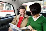 Couple reading map in London Taxi