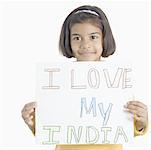 Portrait of a girl holding a placard displaying I Love My India