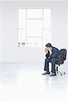 Businessman sitting on a chair and thinking