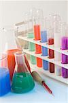 Test tubes in a test tube rack with conical flasks