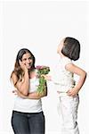 Side profile of a girl giving a bunch of flowers to her mother