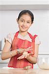 Portrait of a girl preparing food in a domestic kitchen