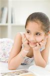 Close-up of a girl reading a book and thinking