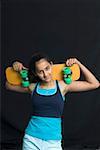 Portrait of a teenage girl holding a skateboard