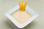 Bowl of cream with mango slices