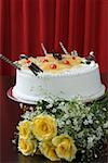 Close-up of a pineapple cake with a bunch of yellow roses