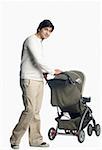 Young man holding a baby stroller