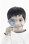 Portrait of a boy holding a light bulb
