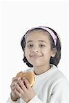 Portrait of a girl eating a hamburger