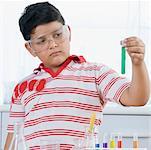 Close-up of a boy holding a test tube