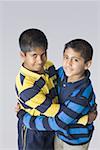 Portrait of two boys hugging each other