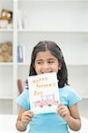 Girl showing her drawing and smiling