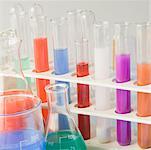 Close-up of test tubes in a test tube rack with conical flasks